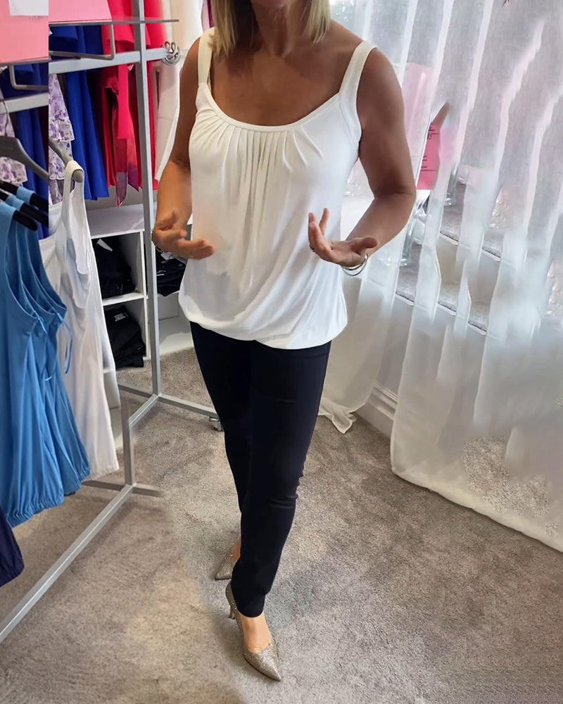 Nancy pleated sleeveless top in white, front view with hands